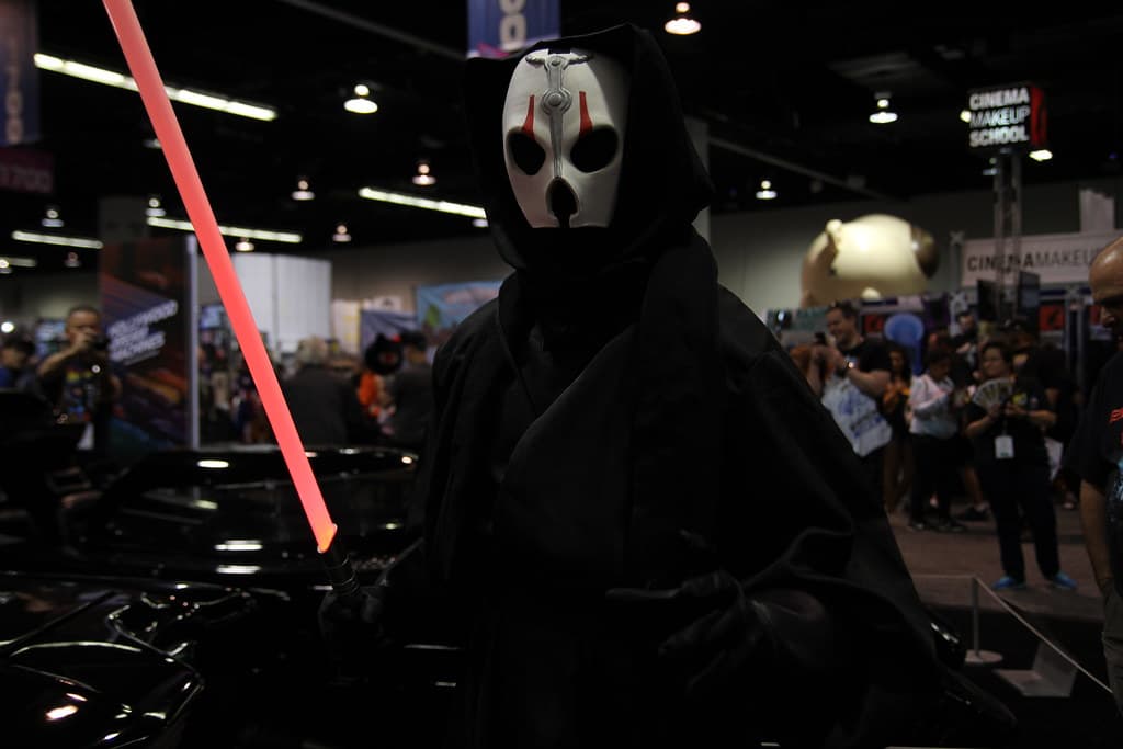 1/6 scale Hot Toys Darth Nihilus figure in layered black robes and white mask, holding a red lightsaber and emitting purple force lightning.
