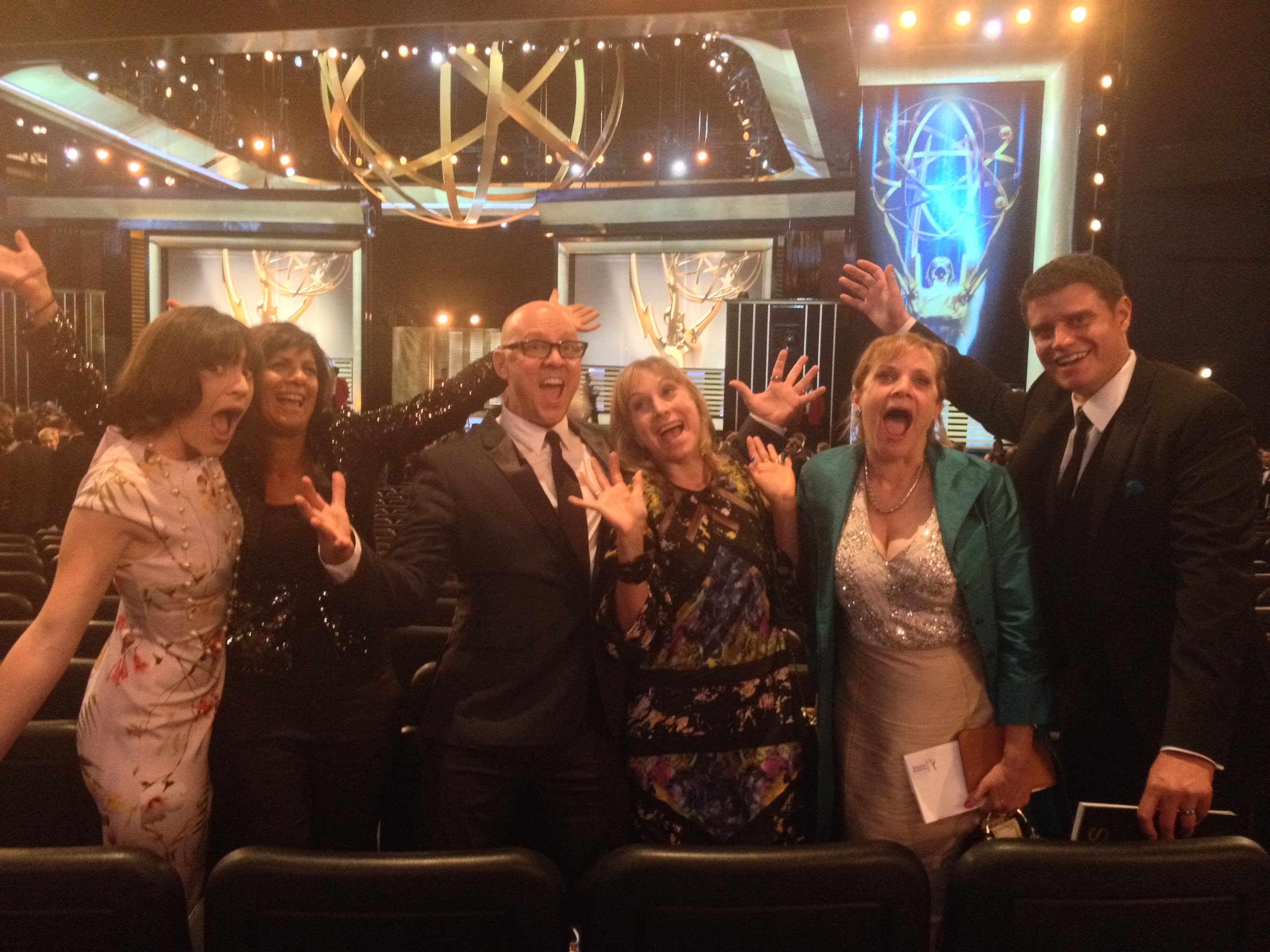 Liza Colón-Zayas and Jeff Hiller smiling together at the Emmy Awards nomination announcement.